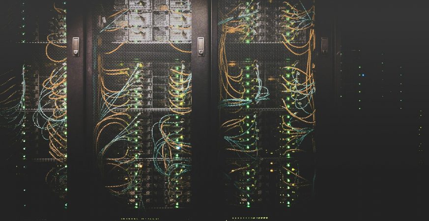 Rows of server racks with bundled network cables inside a data centre