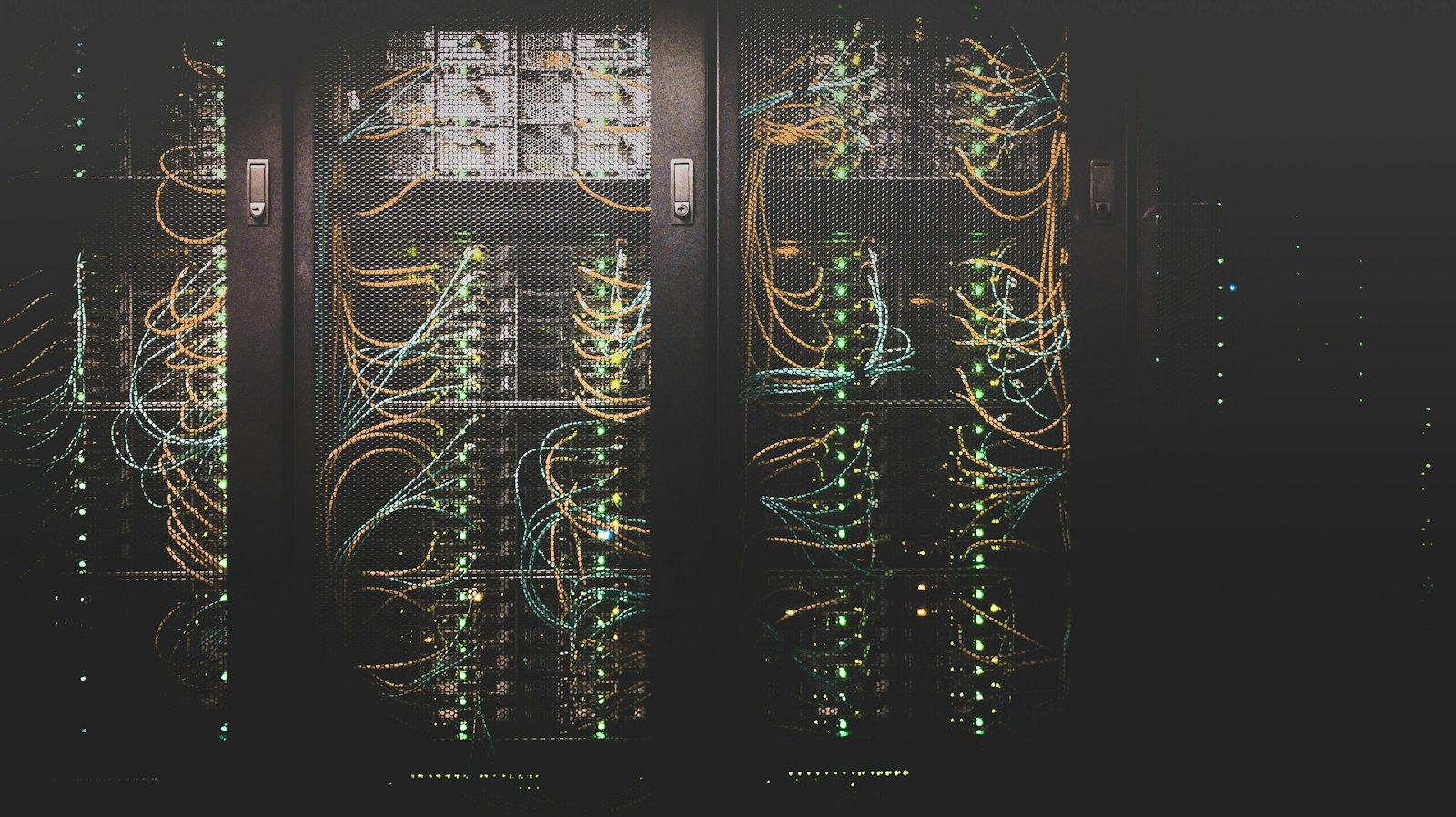 Rows of server racks with bundled network cables inside a data centre