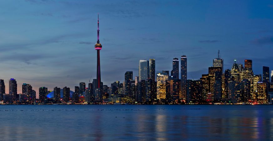 The CN Tower and illuminated downtown Toronto skyline at night, seen from the Toronto Islands