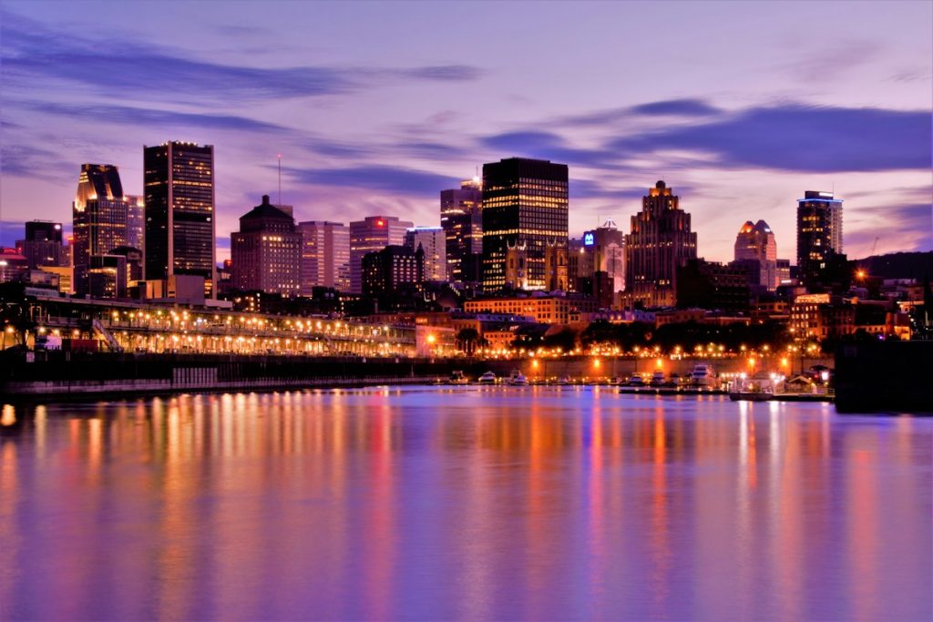 Downtown Montreal skyscrapers lit up at dusk, seen from Parc de la Cité-du-Havre