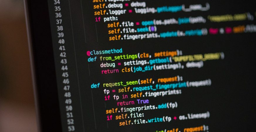 Close-up of a computer screen showing lines of colourful source code