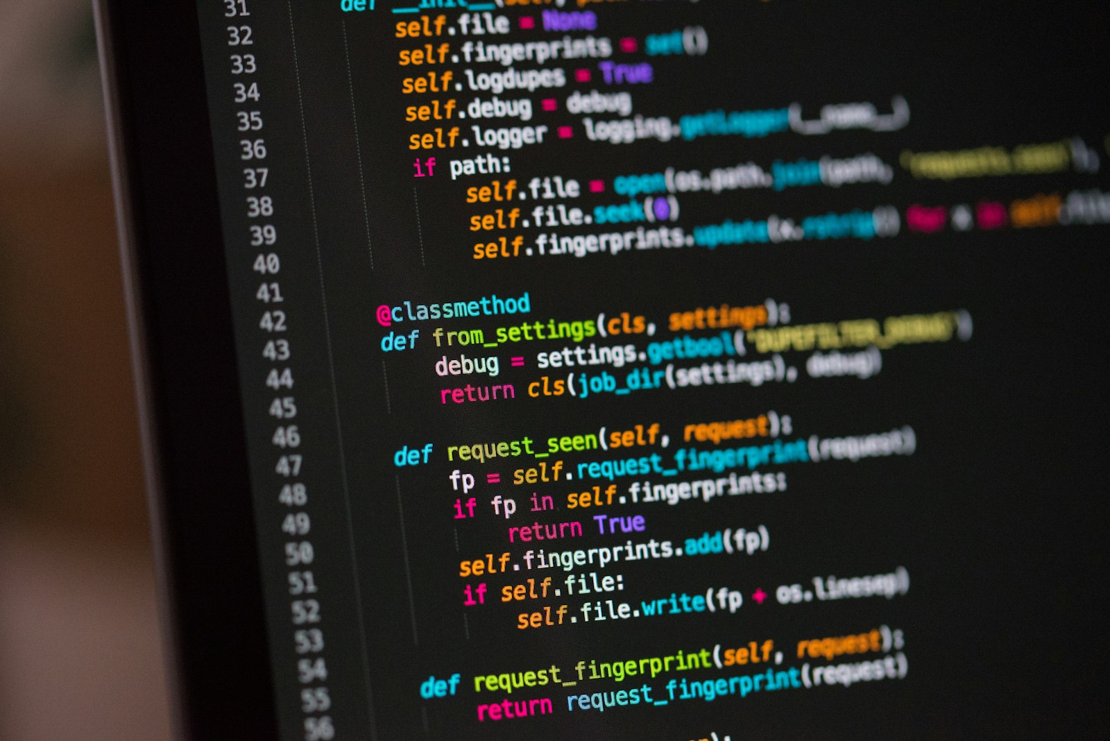 Close-up of a computer screen showing lines of colourful source code