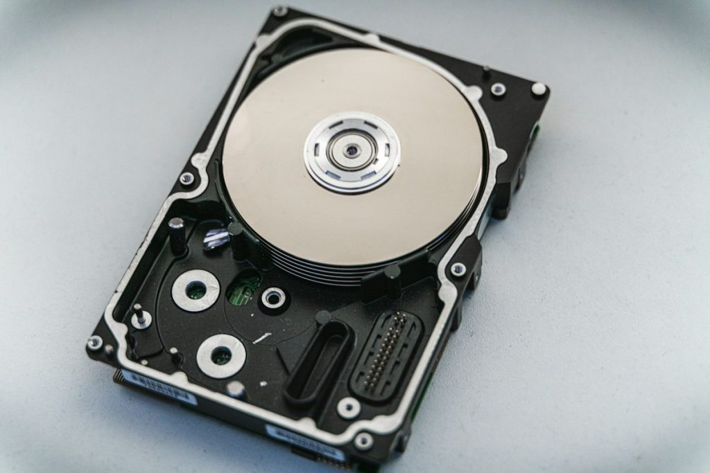 Close-up of an opened hard disk drive showing the platter and read arm