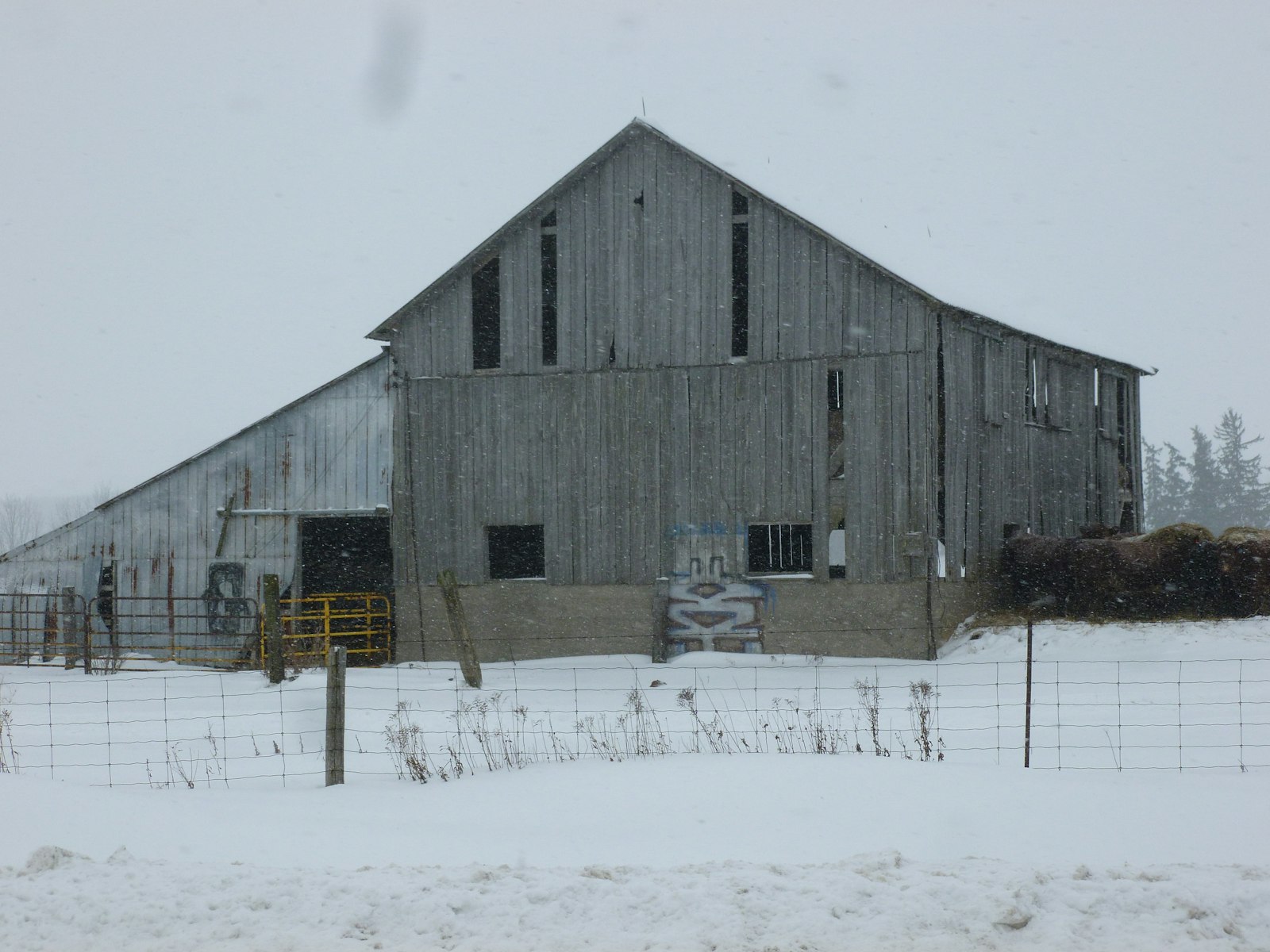 A barn standing alone in a snow-covered field in rural Ontario