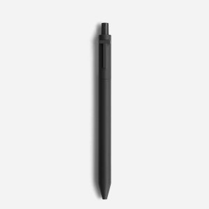 Plain black ballpoint pen lying on a white background