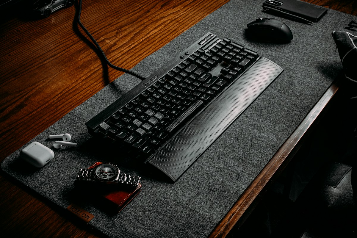 Computer keyboard resting on a felt desk pad