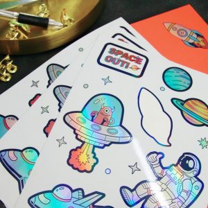 Sheet of holographic die-cut stickers with space-themed designs