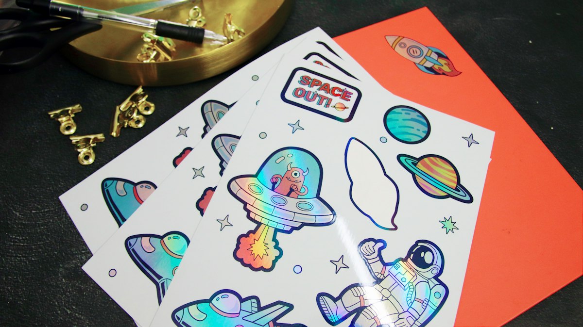 Sheet of holographic die-cut stickers with space-themed designs